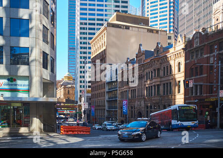 A view of Bridge Street from George Street in the early morning sun with traffic showing the old and new buildings of Sydney, NSW, Australia Stock Photo
