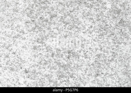 Rough Concrete Wall Decoration, Painted White. White Concrete Wall with Many Protruding Stones. Stock Photo