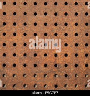 Rusty Texture of Perforated Metal with Regular Pattern of Holes. Stock Photo