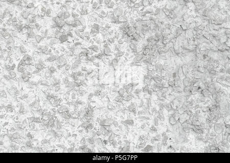 Rough Concrete Wall Decoration, Painted White. White Concrete Wall with Many Protruding Stones. Stock Photo