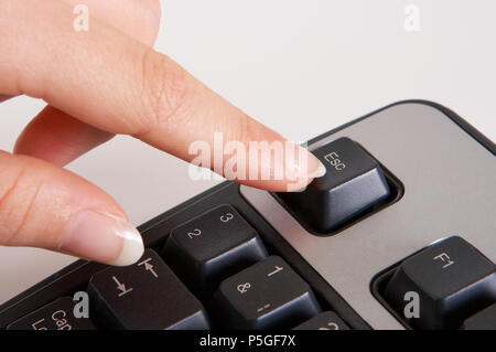 Well manicured finger pressing the computer button :  ESC Stock Photo