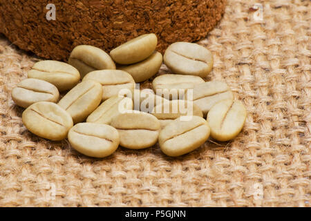 Green coffee beans on burlap Stock Photo