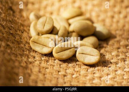 Green coffee beans on burlap Stock Photo
