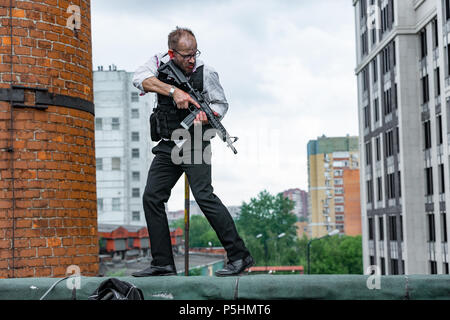 Powerful man Holding Gun. War Action Movie Style Stock Photo