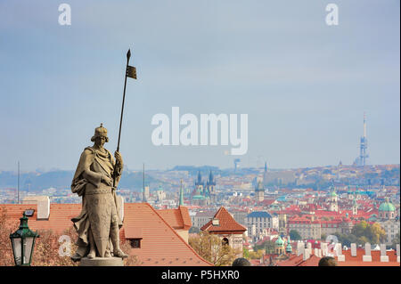 St. Wenceslas statue overlooks Prague city. Sculpture by Cenek Vosmik in Hradcany Square at Prague Castle. Saint with shield and spear against skyline Stock Photo