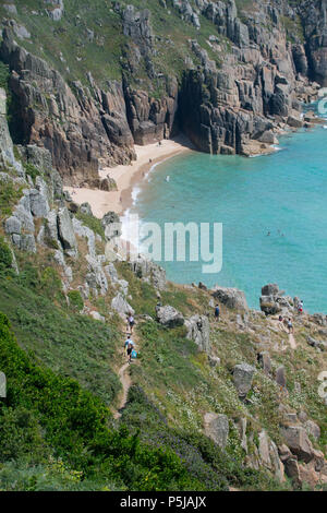 Treen, Cornwall, UK. 27th June 2018. UK Weather. On the hottest day of the year so far, people were making the most of the secluded beach at Treen, near Porthcurno in Cornwall. Credit: cwallpix/Alamy Live News Stock Photo