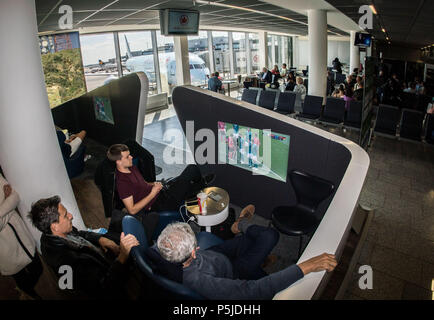 27 June 2018, Frankfurt am Main, Germany:   Matias, Emiliano and Reinaldo from Buenos Aires are following the World Cup encounter between Germany and South Korea at the departure area before returning home. All three were at the World Cup encounter in Russia between Argentina and Nigeria the day before. Football fans can at least partially follow the game even if their flight plan collides with the game. Photo: Frank Rumpenhorst/dpa Stock Photo