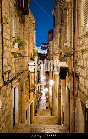 Classic vertical view of small alleyway in the old town of Dubrovnik, in beautiful morning twilight before sunrise at dawn in summer, Dalmatia, Croati Stock Photo