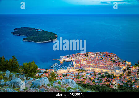 Panoramic aerial view of the historic town of Dubrovnik with Lokrum island in beautiful evening twilight at dusk, Dalmatia, Croatia Stock Photo