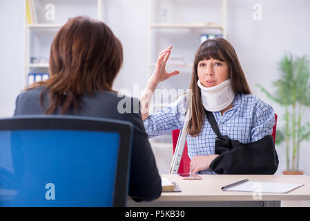 Injured employee visiting lawyer for advice on insurance Stock Photo