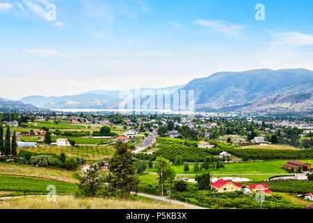 Aerial view of numerous Kelowna vineyards surrounding Lake Okanagan with mountains in the background. Kelowna is renowned for its wineries and winemak Stock Photo