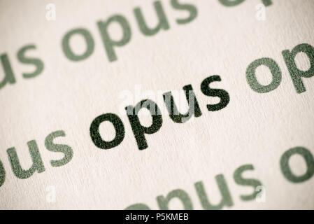 word opus printed on white paper macro Stock Photo