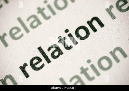 word relation printed on white paper macro Stock Photo