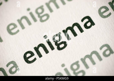 word enigma printed on white paper macro Stock Photo
