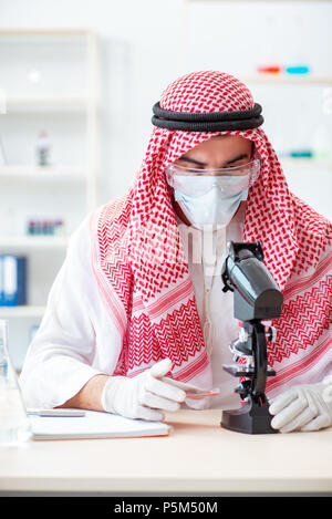 Arab doctor chemist studying new virus in lab Stock Photo