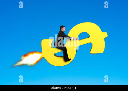 Sitting on money rocket in blue sky Stock Photo