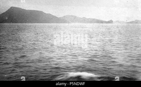 N/A. English: Photograph showing part of the Strait of Bab el-Mandeb looking east towards the Yemeni coast. The promontory on the left is Ras Menheli, the highest of the half dozen promontories and outcrops at the tip of the Bab el-Mandeb Peninsula, also known as the Sheikh Said Peninsula. Taken by a passenger of a passing steamer 10 January 1884. Français : Vue partielle du détroit de Bab el-Mandeb et de la côte du Yémen. Le promontoire à gauche est Ras Menheli, le plus haut des promontoires situés à l'extrémité de la péninsule de Bab el-Mandeb, aussi connue sous le nom de péninsule de Cheikh Stock Photo