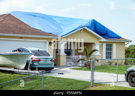 Fort Ft. Myers Florida,Lehigh Acres,after Hurricane Irma storm wind damage destruction aftermath,blue tarp waterproof covering roof,house home houses Stock Photo