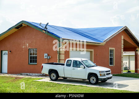 Fort Ft. Myers Florida,Lehigh Acres,after Hurricane Irma storm wind damage destruction aftermath,blue tarp waterproof covering roof,house houses home Stock Photo