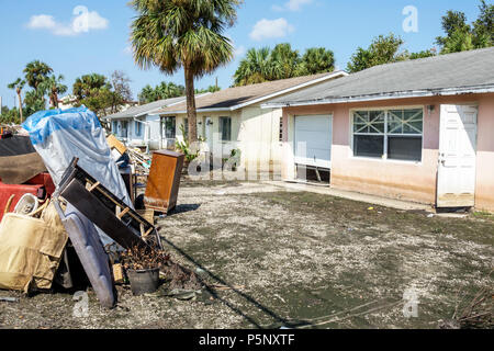 Florida,Bonita Springs,after Hurricane Irma storm water damage destruction aftermath,flooding,house home,front yard,debris trash pile,damaged furnitur Stock Photo