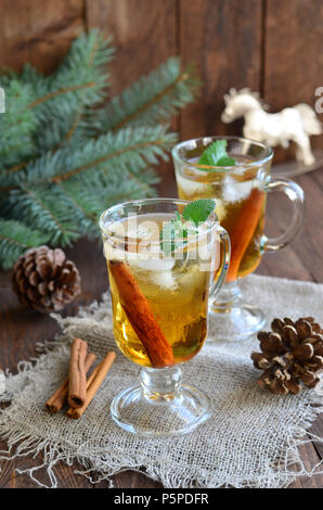 Whiskey cocktail with cinnamon on Christmas background Stock Photo
