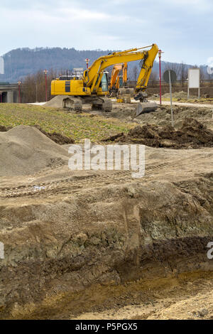 excavators at a loamy construction site Stock Photo - Alamy