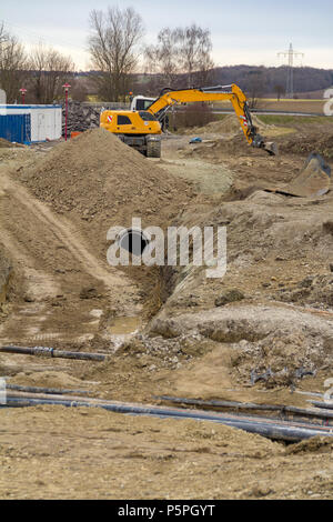excavator at a loamy construction site Stock Photo - Alamy