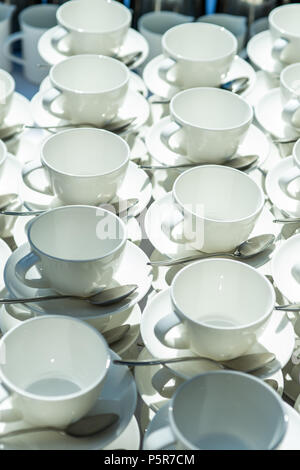 Abstract blurred many rows of coffee or tea cups with coffee dispenser Stock Photo