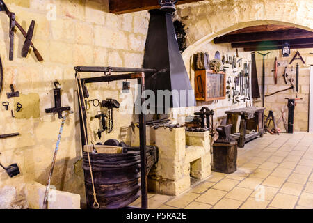 Old traditional tools hanging on a wall in a wood and metal working workshop. Stock Photo