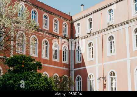Traditional European old architecture. The corner of a typical building in Lisbon in Portugal. The shadow falls from one side to the wall of the house Stock Photo
