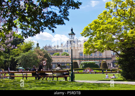 VIENNA, AUSTRIA - MAY 6, 2012: Some people enjoy a sunny recreational day at the Stadtpark Vienna with the Kursalon Stock Photo