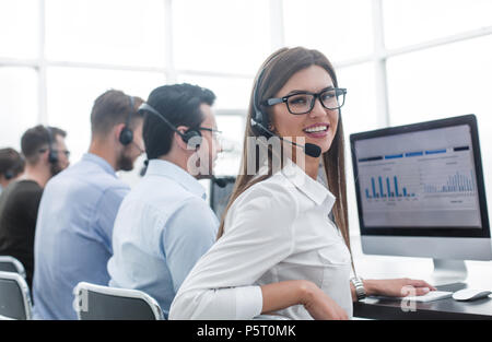 employee of the business center using the computers to analyze the data Stock Photo