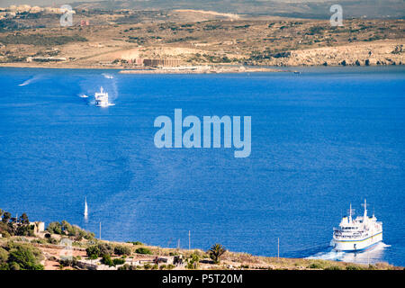 Ferries from the Gozo Channel Company shuttle passengers and cars across the Comino Channel between Malta and Gozo. Stock Photo