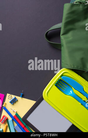 Concept back to school apple backpack stationery on black background. Top view Flat lay Stock Photo