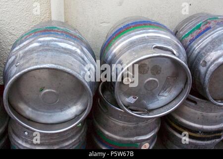 Stacked empty beer kegs outside a pub Stock Photo