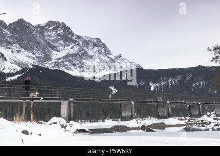 bridge over the lake eibsee in winter in Germany. Stock Photo