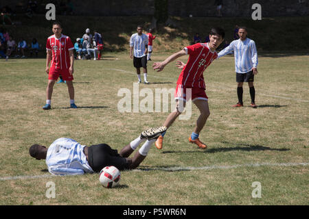 A footballer falling after being fouled. Stock Photo