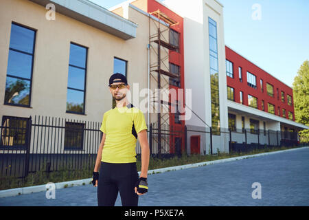 A man in sportswear is standing on the street. Stock Photo