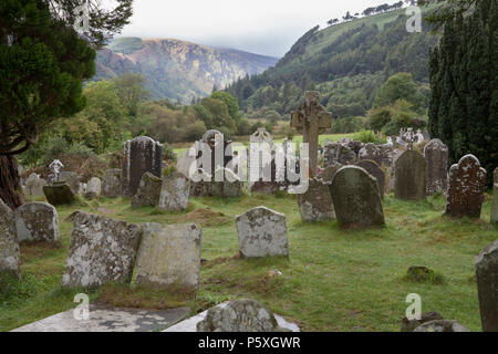 Ancient lichen and moss covered gravestones at Glendalough Monastic Site in County Wicklow, Ireland Stock Photo