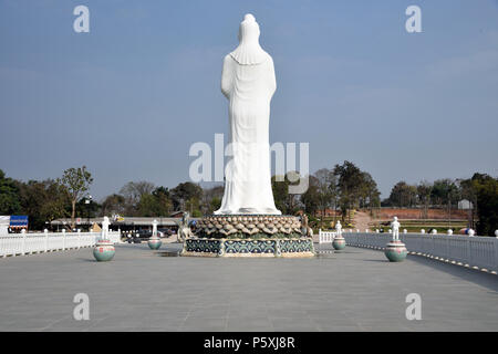 The recent addition to Wat Pa Huai Lat Temple complex in Northern Thailand - a large white Buddhist figure in a compound guarded by two temple lions Stock Photo