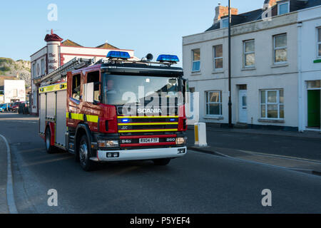 Image of  a Fire engine, the Wiltshire and Dorset Fire Brigade on a call to attend an emergency. Image taken July 2013 at Portland, Dorset. Stock Photo