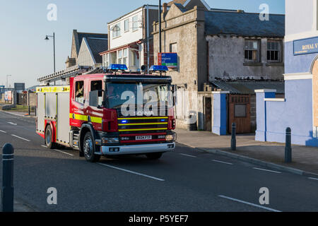 Image of  a Fire engine, the Wiltshire and Dorset Fire Brigade on a call to attend an emergency. Image taken July 2013 at Portland, Dorset. Stock Photo