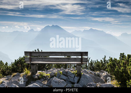 Empty park bench in high mountains, view from Eagles nest in the bavarian Alps near Berchtesgaden in Germany Stock Photo