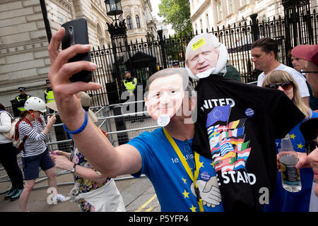 London, UK. 23rd June 2018. A protester wearing David Cameron and Boris Johnson masks takes a selfie outside 10 Downing Street. March for a Peoples Vo Stock Photo