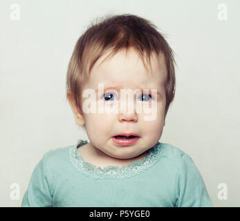 Small Baby Girl Crying. Sad Child Stock Photo