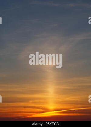 Rare Sun Pillar cirrus cloud  phenomenon above a vivid sunset over Aylesbury Vale, Buckinghamshire seen around midsummer. Stock Photo