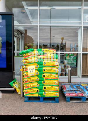 Pallet full of bags of potting compost outside a Tesco supermarket Stock Photo