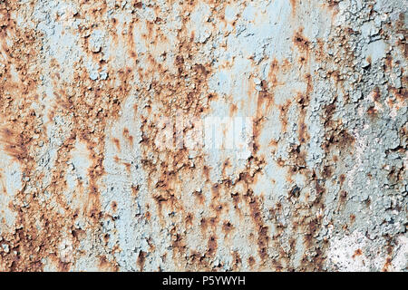 Grunge texture of old cracked blue paint with cracks and rust spots. Rough rustic background. Retro textured wall. Stock Photo