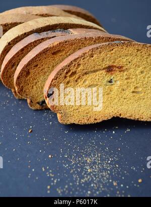 Rusk biscuit with crumbs on black background Stock Photo