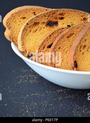 Rusk biscuit with crumbs on black background Stock Photo
